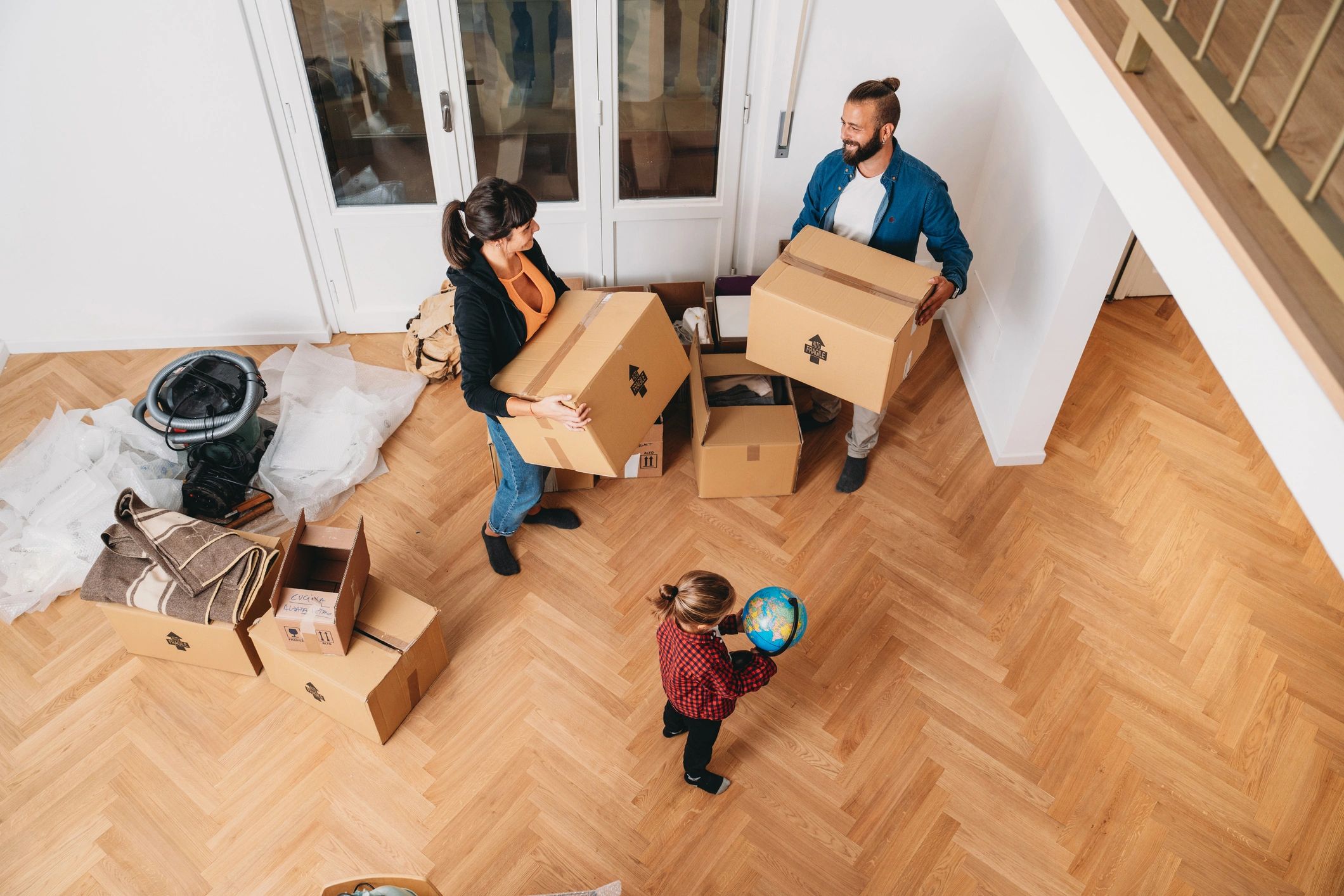 Family settling into a new house with moving boxes