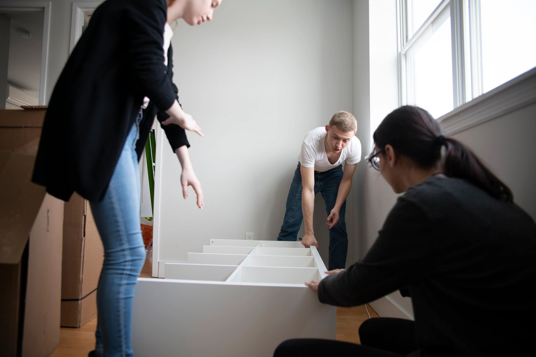 Family unpacking furniture after a move